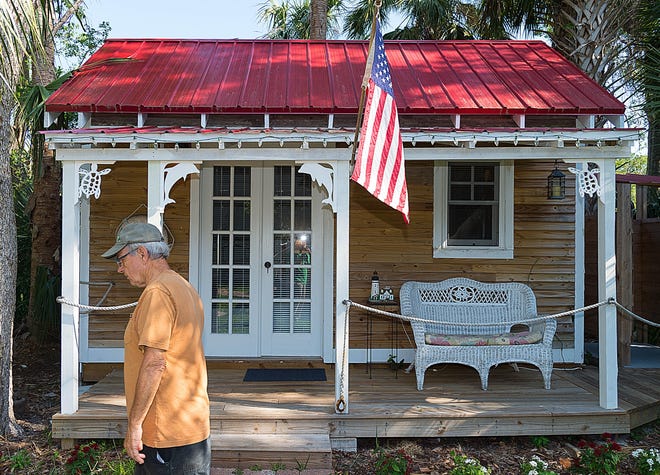 Tom Gibes walks past the one-bedroom cottage on his property in St. Augustine that he rents through the website Airbnb. Gibes uses the money from the rentals to supplement his retirement income. [PETER WILLOTT/THE RECORD]