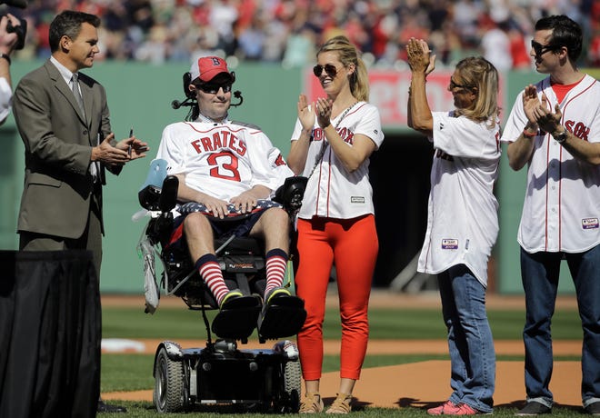 Pete Frates, a former Boston College baseball player stricken with ALS, is applauded by then-Red Sox general manager Ben Cherington far left, his wife, Julie Frates, middle, his mother, Nancy, and his brother, Andrew, prior to the home opener in April of 2015. [AP Photo / Elise Amendola]