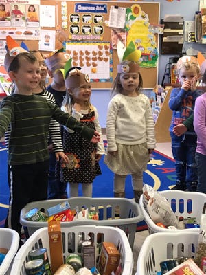 The Joyful Noise preschool students and families donated over 20 baskets filled with canned goods to Saint Anne’s of Raynham that then goes to the food pantry at St. Vincent De Paul Society. [Courtesy Photo]