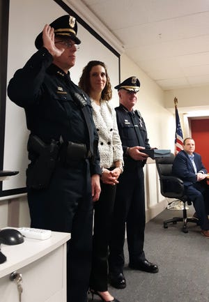 Newly appointed YPD Deputy Chief Kevin Lennon is sworn in Tuesday evening with his wife Sondra and Chief Frank Frederickson by his side. [PHOTOS BY SILENE GORDON]