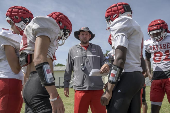 Tavares head coach Gary Dugger gathers his offense during spring football practice in May at Tavares High School. On Tuesday, Dugger announced his resignation to accept a position as an assistant coach in Alabama. [PAUL RYAN / CORRESPONDENT]