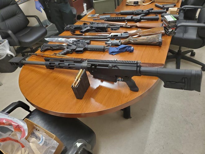 Volusia County deputies said this .50 caliber rifle was among many seized from a Deltona man arrested in the nude after contacting his wife against a court order.