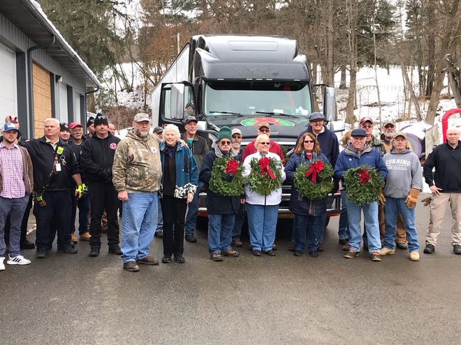 On Monday, a truckload of wreaths arrived at the Bath VA for the Dec. 14 Wreaths Across America (WAA) Day event in the Bath National Cemetery. This year there are 5,000 wreaths that will be placed on Veterans graves. Local independent truck driver, Kent Tryon, delivered the wreaths, arriving around noon on Monday where many volunteers were ready to unload and transfer the wreaths to other vehicles. [PROVIDED]