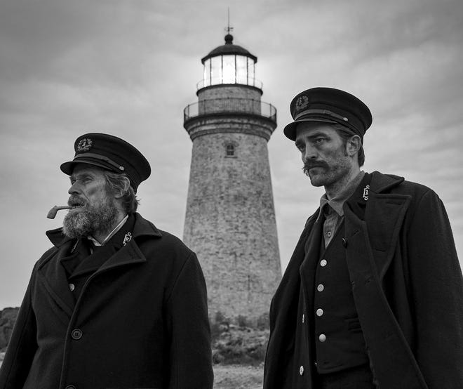 This image released by A24 Films shows Willem Dafoe, left, and Robert Pattinson in a scene from "The Lighthouse." The Safdie brothers’ Diamond District crime film “Uncut Gems” and Robert Eggers’ fever-dream period tale “The Lighthouse” lead the 35th annual Film Independent Spirit Awards with five nominations each. The Spirit Awards will be held Feb. 8, the day before the Academy Awards. (Eric Chakeen/A24 Pictures via AP)