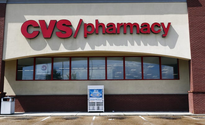 In this Aug. 7, 2018, file photo a CVS Pharmacy building sign rests on a Jackson, Miss., store. (AP Photo/Rogelio V. Solis, File)