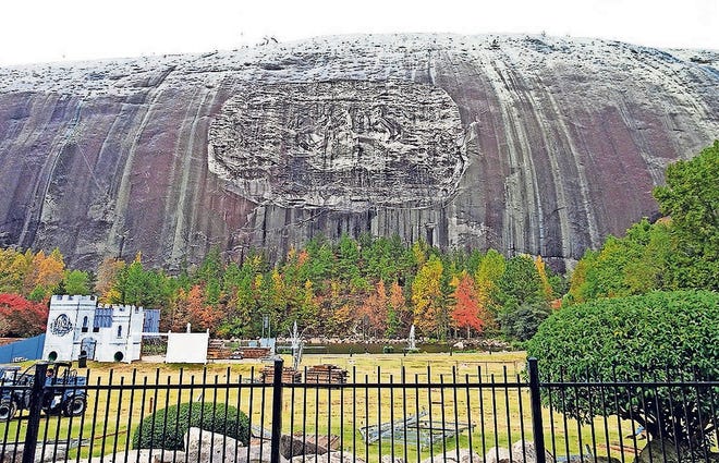 A large carving of Robert E. Lee, Jefferson Davis and Stonewall Jackson draws visitors to Stone Mountain. [CR RAE]