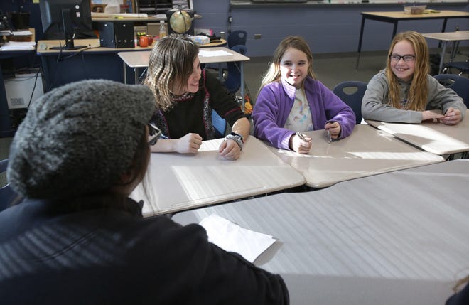 Fairless Middle School students (from left) Hailey Miller, Kaydence Gorby and Jayla Bender talk about the highs and lows of their week as Legacy Project mentor and Program Director Jenn Warner listens. (IndeOnline.com / Kevin Whitlock)