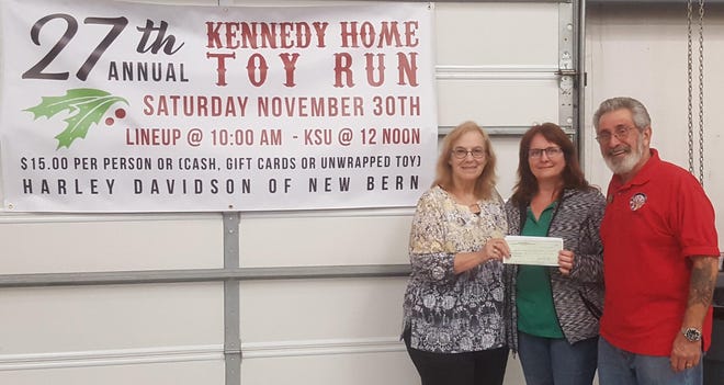 Elks Kathy and Tom Perretta present Sheila Plunkett, GM of New Bern Harley Davidson, with a $500 sponsorship check for the 27th Kennedy Home Toy Run. The donation is from New Bern Elks Lodge #764 Committee of One Hundred. The home provides for children and families in dire need and distress. This year's event was attended by five hundred forty seven motorcyclists and raised just over nineteen thousand dollars. [CONTRIBUTED PHOTO]