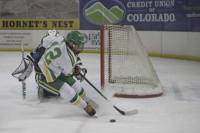 Pueblo County High School's Luke Guarienti puts on the brakes to reverse the puck against Air Academy on Thursday at the Pueblo Ice Arena. [CHIEFTAIN PHOTO/ZACHARY ALLEN]