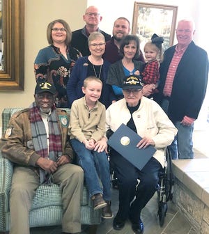 Fort Smith Mayor George McGill, left, sits with Harold Mainer, right, and members of the Mainer family on Saturday, Dec. 7, 2019. McGill surprised Mainer with a proclamation from the City of Fort Smith for his military service and being one of only two Pearl Harbor survivors in Arkansas. Veteran and Project Compassion volunteer, Charlie Davis, helped to organize the event to recognize Mainer. [PHOTO SUBMITTED BY MARIAN CONRAD]