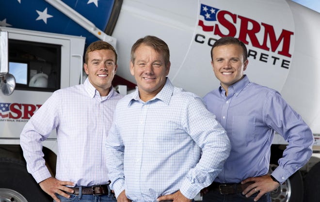 SRM Concrete founder and President Mike Hollingshead, center, is shown with sons Ryan, left, and Jeff in front of a cement truck in this company-provided image. [SPECIAL]
