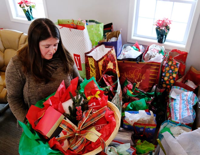 Amy Head, Choices for Independence specialist at Meals on Wheels in Brentwood, sorts through the hundreds of gifts for clients at the Rockingham County Meals on Wheels headquarters on Friday.

[Rich Beauchesne/Seacoastonline]