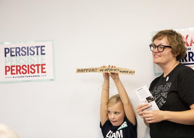 Amelia Peek, 6, holds a homemade sign while standing next to her mother, Whitney, 39, celebrating the opening of a campaign office for Democratic presidential candidate U.S. Sen. Elizabeth Warren, D-Mass, in Austin on Saturday. [ANA RAMIREZ/AMERICAN-STATESMAN]