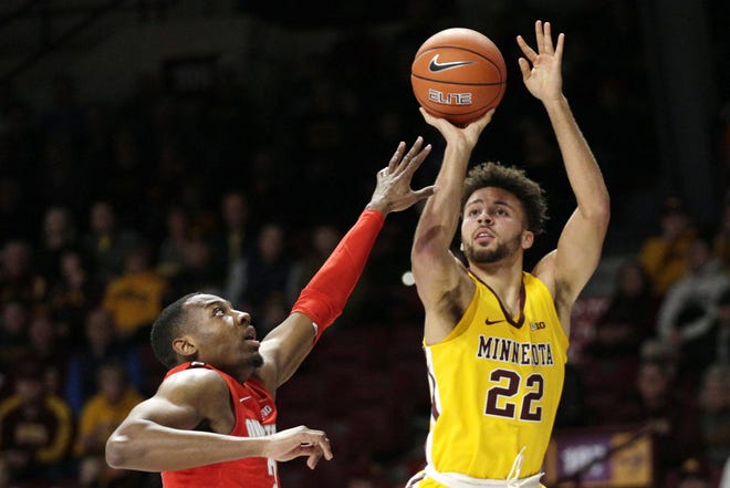 Minnesota guard Gabe Kalscheur (22) shoots over Ohio State guard D.J. Carton in the first half of an NCAA basketball game Sunday, Dec. 15, 2019, in Minneapolis. (AP Photo/Andy Clayton-King)