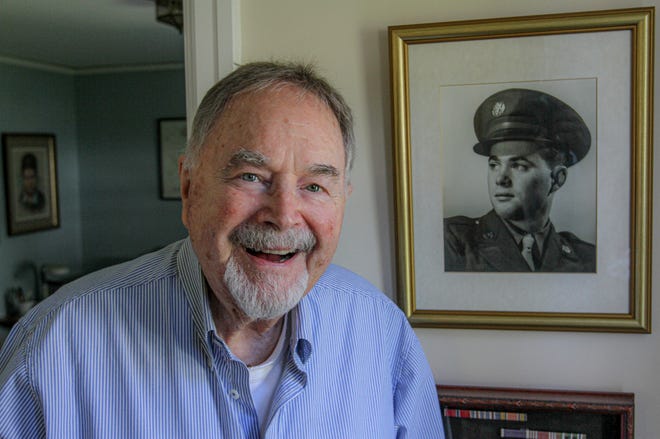 Frank Marshall poses with his service portrait at his Tiverton home. [DAVID DELPOIO/THE PROVIDENCE JOURNAL]