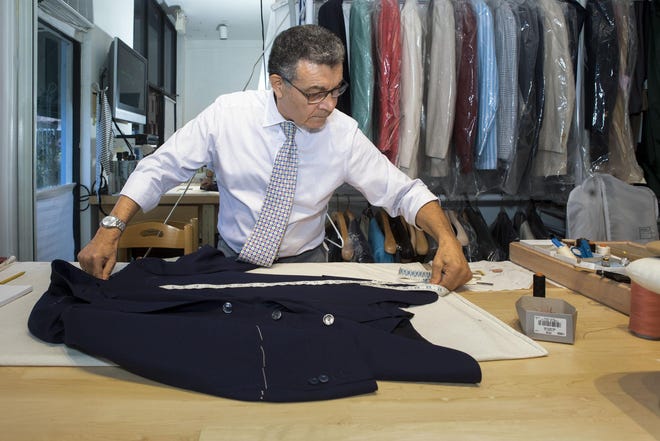 Amadeu Santos, 68, who has worked as tailor at TRILLION for 18 years, works on a men's suit jacket Nov. 22, 2019. [DAMON HIGGINS/palmbeachdailynews.com]