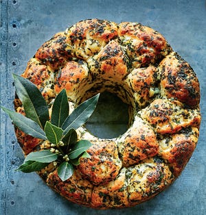 Donna Hay’s new cookbook, “Christmas Feasts and Treats,” includes this wreath-shaped pull-apart bread. [Contributed by Con Poulos]