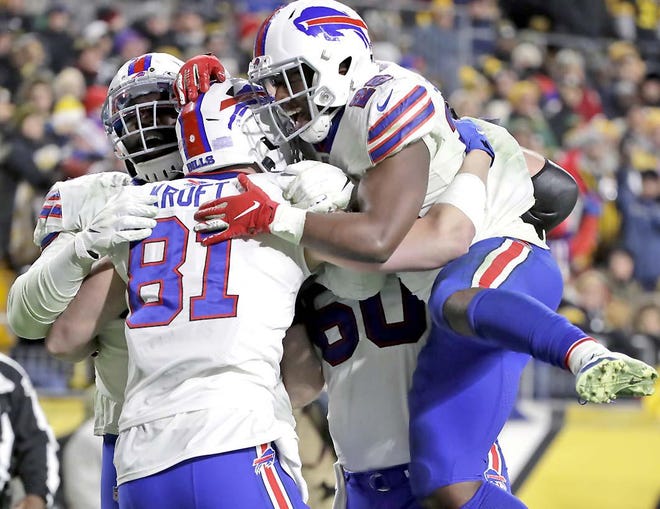 Buffalo Bills tight end Tyler Kroft (81) celebrates with running back Devin Singletary (26) and others after scoring on a pass from quarterback Josh Allen during the second half of Sunday’s game against the Pittsburgh Steelers in Pittsburgh. [Don Wright / Associated Press]