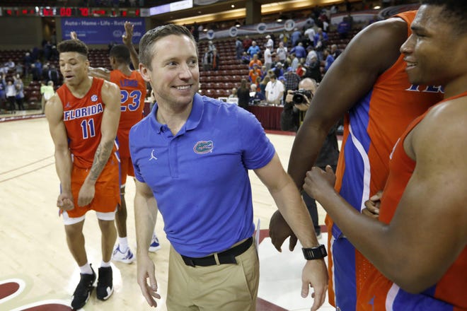 Florida's head coach Mike White celebrates after defeating Xavier 70-65 in an NCAA college basketball game during the finals of the Charleston Classic Sunday, Nov. 24, 2019, in Charleston, SC. (AP Photo/Mic Smith)
