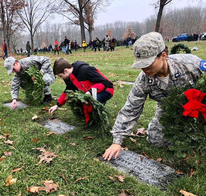 [COURTESY HEATHER TRITCHKA] Hillsdale Civil Air Patrol Cadets place wreaths during a ceremony at Fort Custer National Cemetary in Battle Creek on Saturday.
