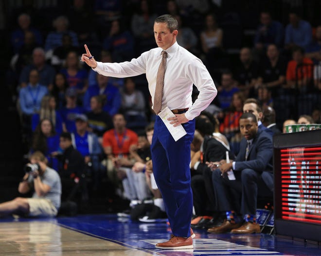 Florida coach Mike White motions to his team during the first half of an NCAA college basketball game against Marshall on Friday, Nov. 29, 2019, in Gainesville, Fla. (AP Photo/Matt Stamey)