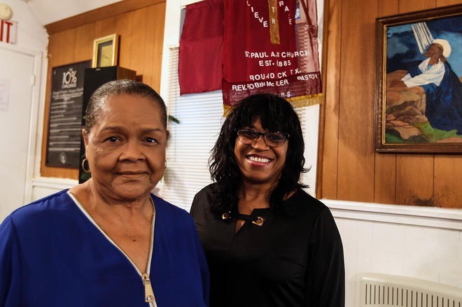 Ella Sauls Morrison and her niece, Tina Steiner, stand inside St. Paul African Methodist Episcopal Church of Round Rock. Morrison’s father, Otto “Winzell” Sauls, helped relocate and rebuild the church. [PHOTO BY ARIANA GARCIA]