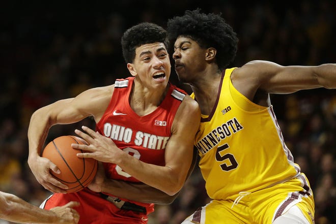 Minnesota guard Marcus Carr (5) plays defense against Ohio State guard D.J. Carton (3) in the second half during an NCAA college basketball game Sunday, Dec. 15, 2019, in Minneapolis. (AP Photo/Andy Clayton-King)