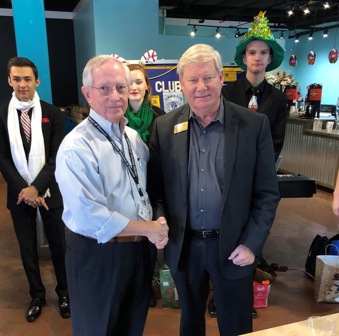 Charles Clary, past president of the Destin Kiwanis (left), presents a check for $1,400 to Ken Hair, CIC president/CEO, to help feed, clothe, and provide a home to the children living at the CIC Neighborhood. [CONTRIBUTED PHOTO]