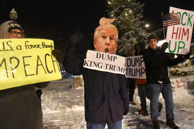 Demonstrators calling for the impeachment of President Donald Trump gathered for a "Nobody Is Above the Law" rally held Tuesday evening at Henry Law Park in Dover, one of hundreds of rallies held nationally. [Deb Cram/Fosters.com]