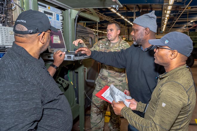Workers participate in a weeklong operator familiarization course focusing on the AN/TSC-156 Phoenix Multi-Channel Tactical Satellite Communication Terminal. [THOMAS ROBBINS/TOBYHANNA ARMY DEPOT]