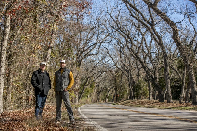 Bradley Taylor, left, and Brian Ender are trying to save trees along Hairy Man Road in Round Rock from being removed to widen the road. [JAY JANNER/AMERICAN-STATESMAN]