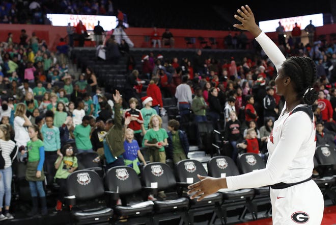 Georgia guard Maya Caldwell waves to her young fans during an NCAA women's college basketball game between Georgia and Lipscomb last season during the annual education game. Georgia won 77-45. [Photo/ Joshua L. Jones, Athens Banner-Herald]