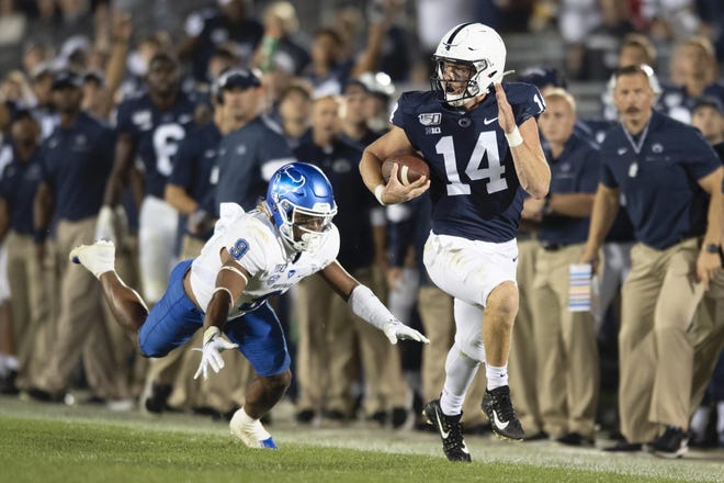 Penn State quarterback Sean Clifford picks up significant yardage against Buffalo. [BARRY REEGER / ASSOCIATED PRESS FILE]