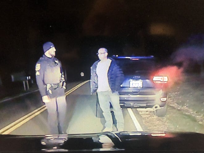 Sgt. Ryan Grossman of the Washington Police Department, left, is seen on a car dashboard camera speaking to Chad Lacost, a deputy chief of the East Peoria Police Department, during a traffic stop on Nov. 23. Lacost is accused of speeding and then refusing to get out of his car. [SOURCE: Washington Police Department]