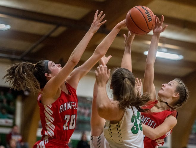Brimfield´s Ella Lune, left, and Elly Doe, right, battle for a rebound with Eureka´s Maddy Farney in the second half Monday in Eureka. Brimfield defeated the Hornets 75-44 in a battle of two of the area's top small-school teams. [MATT DAYHOFF/JOURNAL STAR]