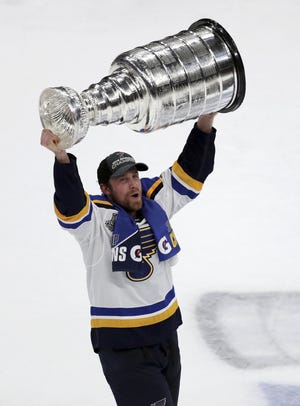 The St. Louis Blues' Jaden Schwartz, a former Peoria Rivermen player, carries the Stanley Cup after the Blues defeated the Boston Bruins in Game 7 of the NHL Stanley Cup Final on June 12 in Boston. [AP Photo/Charles Krupa]