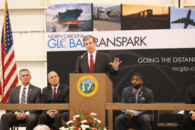 North Carolina Governor Roy Cooper reveals the economic development announcement Thursday, Dec. 19, at the Global TransPark Hangar 4. [Brandon Davis/Kinston Free Press]
