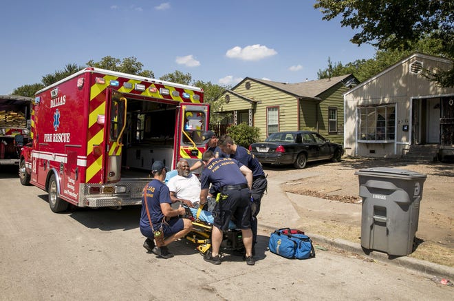 Clyde Jackson, 66, is taken by ambulance from his home on Fordham Road in the Oak Cliff neighborhood in Dallas after he was overcome by the heat on Aug. 16. [JAY JANNER/AMERICAN-STATESMAN]