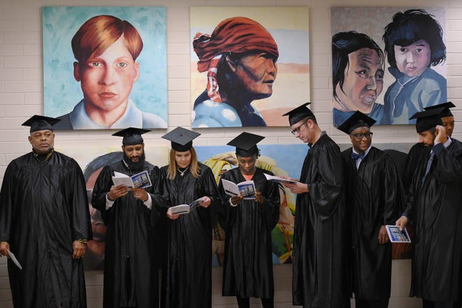 Graduates from the Generation training program get ready for the start of Friday's commencement ceremony at Florida State College at Jacksonville’s downtown campus Friday. [Bob Self/Florida Times-Union]