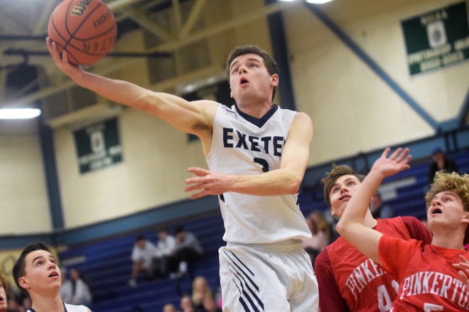 Exeter High School senior Michael Leonard scores an acrobatic layup during Friday night's first quarter against Pinkerton. The defending Division I state champs rolled to their 22nd consecutive victory, 77-29. [Ryan O'Leary/Seacoastonline]