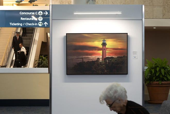 “Jupiter Lighthouse at Sunset" by Sandy Friedkin of Palm Beach Gardens is on display at Palm Beach International Airport. The airport is partnering with the county’s Art in Public Places program to showcase 15 local artists. The exhibition runs through April 8. [GREG LOVETT / palmbeachpost.com]
