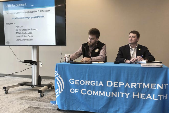 HFM TBA*In this photo taken on Nov. 22, 2019, Ryan Loke, left, Gov. Brian Kemp’s health policy adviser, and Blake Fulenwider, the chief health policy officer for the Georgia Department of Community Health, attend a public hearing in Kennesaw, Ga., about Kemp’s recent health care proposals. (AP Photo/Sudhin Thanawala)