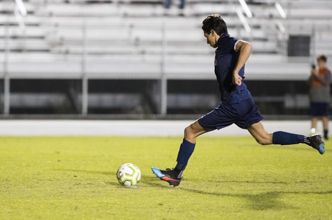 Arnold's Michael Sears scores on a penalty kick against Mosley on Friday, December 20, 2019. [JOSHUA BOUCHER/THE NEWS HERALD]