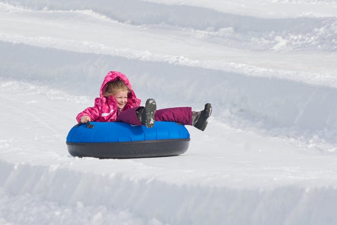 Anna Busic, 7, of Heath, enjoys tubing at Snow Trails in Mansfield on its opening day, Dec. 21.