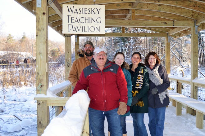Friends and family gather with Steve Wasiesky, front, to celebrate the dedication of the Wasiesky Teaching Pavilion at Asbury Woods in Millcreek Township. Behind Wasiesky, from left, are Carlton Luke, Victoria Ortiz, Andrea Morris and Wasiesky's sister, Sandy Kitts. [CONTRIBUTED PHOTO]