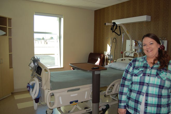 Brecklyn Gustason, the local manager with BreakThru, a medical subtance abuse withdrawal program, shows off one of the private rooms at Summit Surgical where patients in the program will be housed. [John Green/HutchNews]