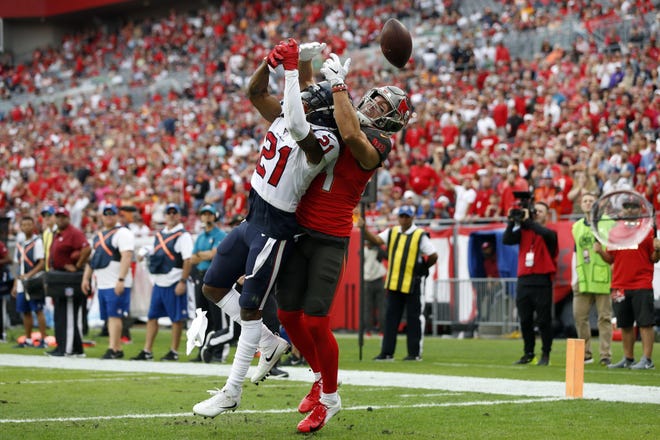 Houston cornerback Bradley Roby, front, breaks up a pass intended for Tampa Bay tight end Cameron Brate during the Texans’ victory Saturday. Houston’s secondary had four interceptions, including a pick six by Roby. [Mark LoMoglio/The Associated Press]