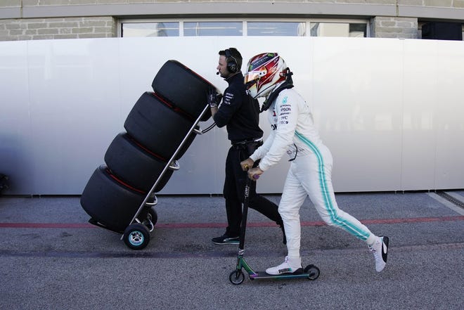 Mercedes driver Lewis Hamilton, of Britain, rides his scooter following the first practice session for the Formula One U.S. Grand Prix auto race at the Circuit of the Americas, Nov. 1, 2019, in Austin, Texas. (AP Photo/Chuck Burton)