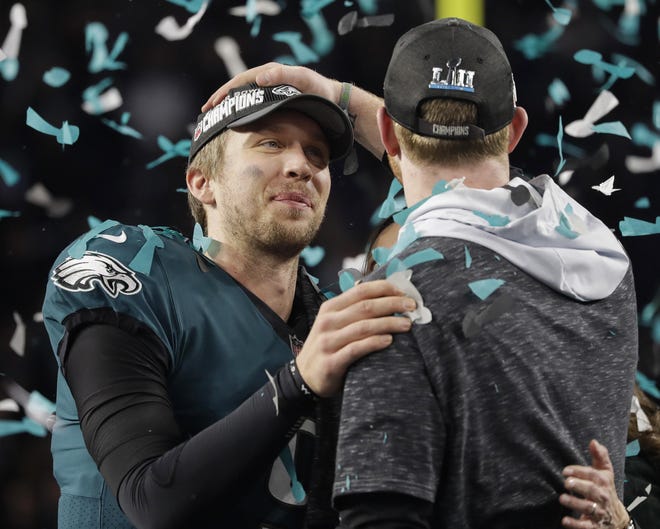 Eagles quarterback Nick Foles, left, celebrates with Carson Wentz after defeating the Patriots 41-33 to win Super Bowl 52 in Minneapolis. [MATT SLOCUM / ASSOCOATED PRESS FILE]
