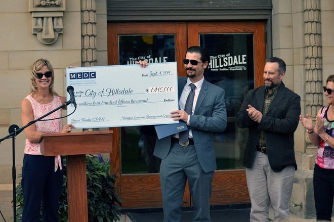 [SAM FRY PHOTO] Paula Holtz of the Michigan Economic Development Corporation presented Hillsdale officials with a check for $1.4 million in September. Funds will be used to restore Dawn Theater in 2020.